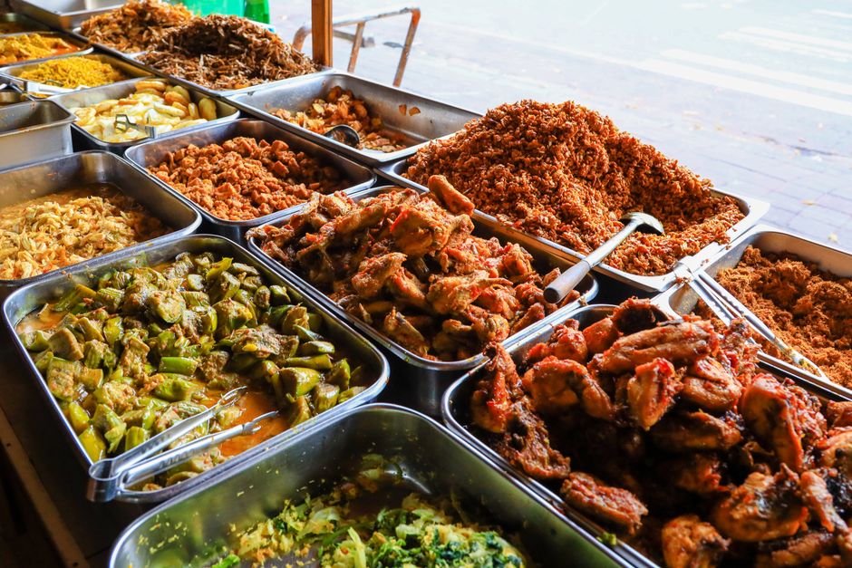 A vibrant display of traditional Balinese street food showcasing a variety of colorful dishes.